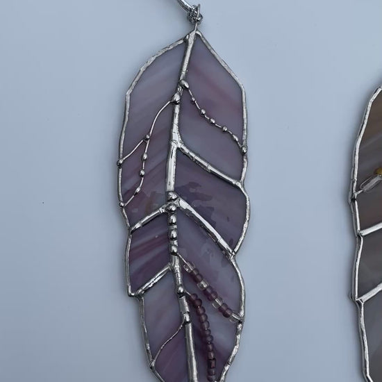 Collection of handcrafted stained glass feathers in purple, amber, bronze, blue and clear art glass