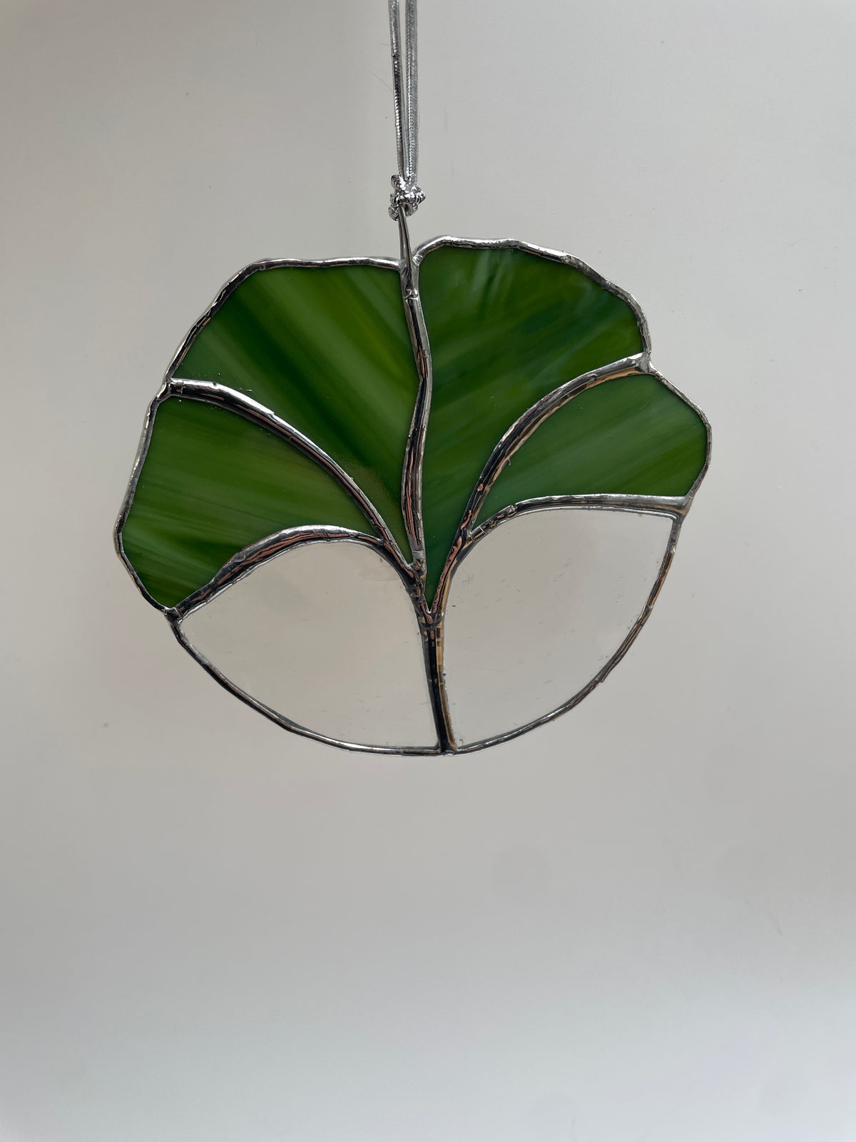 Green stained glass ginkgo leaf suncatcher with clear glass and silver solder